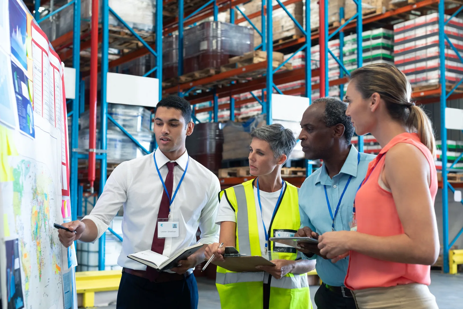 Recruitment team reviewing workforce plans in a warehouse